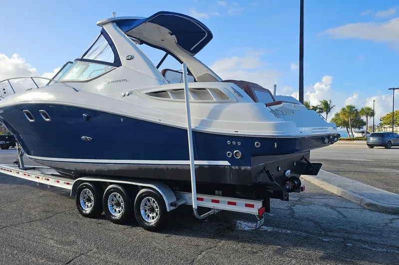 Slide: The Image of 2008 Sea Ray Sundancer 310 on trailer, parked in sunny marina setting. - 62