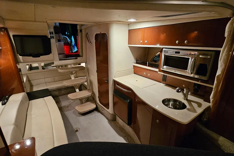 Slide: The Image of Luxurious interior of a 2008 Sea Ray Sundancer 310 yacht with kitchenette and seating area. - 69