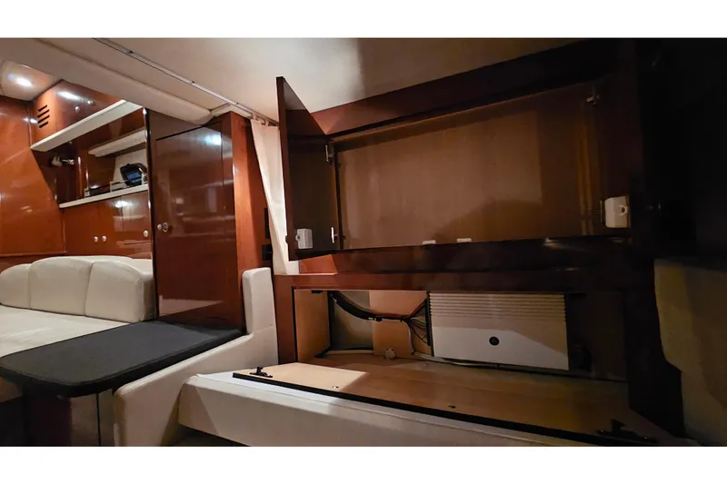 Slide: The Image of Interior of 2008 Sea Ray Sundancer 310, featuring open cabinets and seating area. - 73