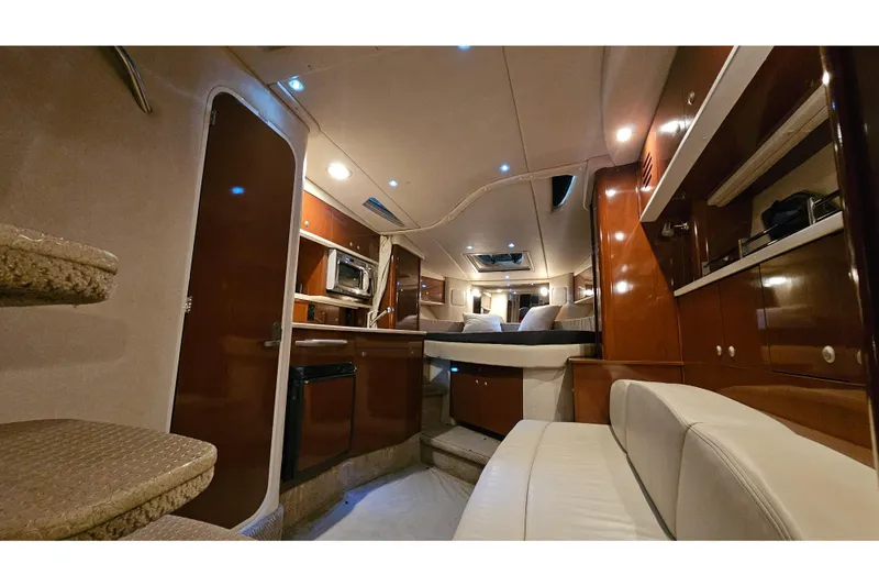 Slide: The Image of 2008 Sea Ray Sundancer 310 interior with modern kitchen, seating, and ambient lighting. - 74