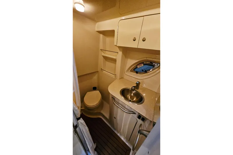 Slide: The Image of 2008 Sea Ray Sundancer 310 bathroom with sink, toilet, and storage cabinets. - 77