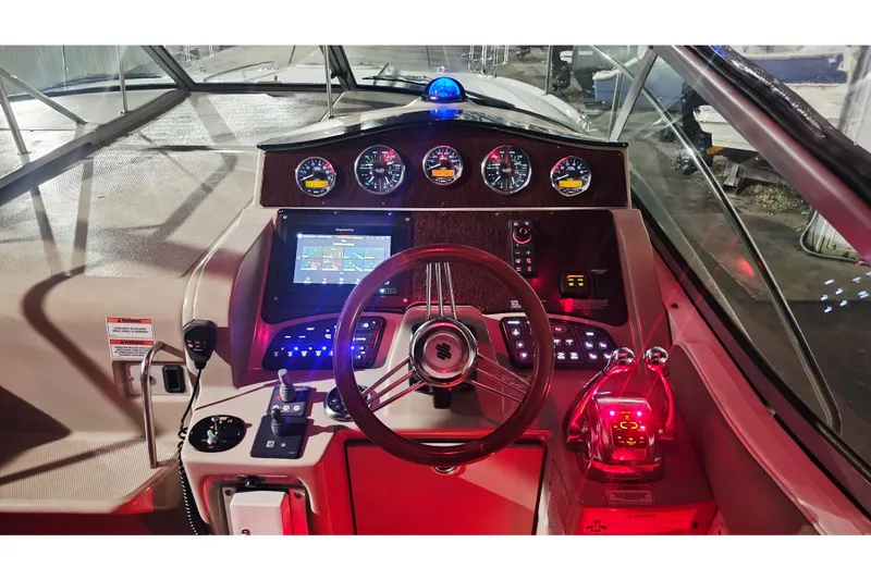 Slide: The Image of 2008 Sea Ray Sundancer 310 helm with illuminated controls and navigation display. - 79