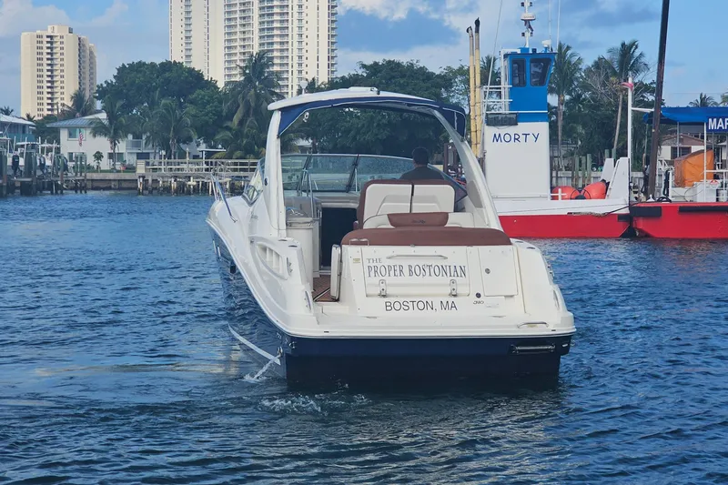 Slide: The Image of 2008 Sea Ray Sundancer 310 boat named "The Proper Bostonian" on water near marina. - 81