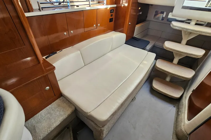 Slide: The Image of Interior of 2008 Sea Ray Sundancer 310 with cream sofa and wooden cabinetry. - 9
