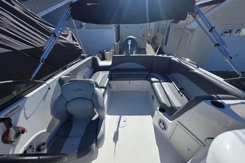 Slide: The Image of 2023 NauticStar 223 DC boat interior with seating and canopy, showcasing modern design. - 14