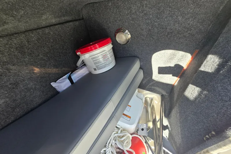 Slide: The Image of Interior storage of 2023 NauticStar 223 DC boat with safety equipment and supplies. - 22