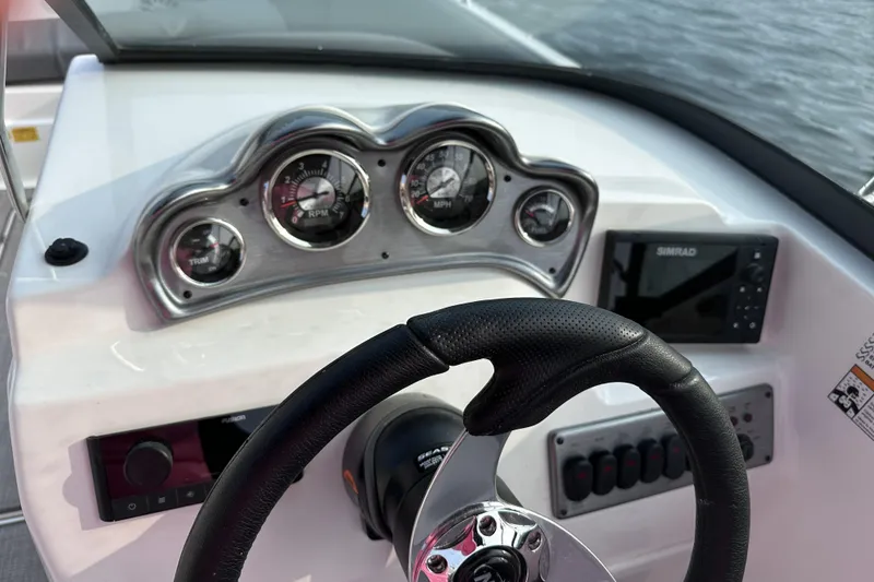 Slide: The Image of 2023 NauticStar 223 DC boat dashboard with steering wheel and gauges. - 5
