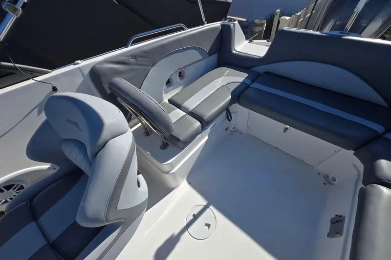 Slide: The Image of 2023 NauticStar 223 DC boat interior with gray seating and modern design. - 9
