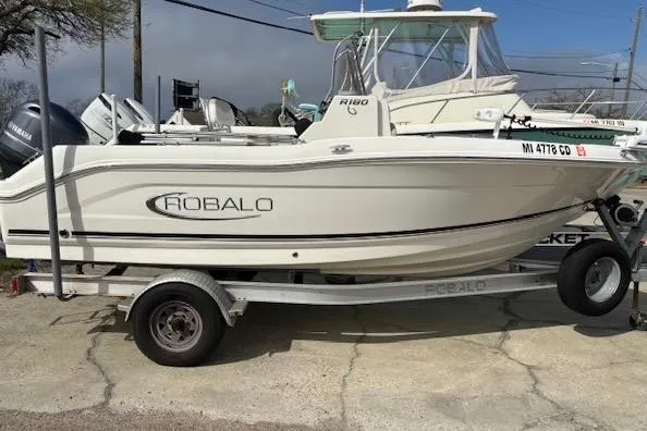 Slide: The Image of 2018 Robalo R180 Center Console boat on trailer, side view. - 3