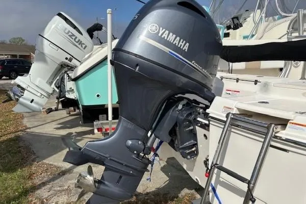 Slide: The Image of 2018 Robalo R180 Center Console with Yamaha outboard motor, parked outdoors. - 8