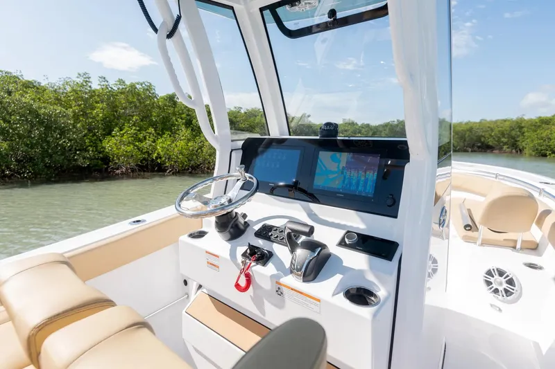 Slide: The Image of Manufacturer Provided Image: 2025 Sportsman Open 232 Center Console boat interior with modern dashboard and steering. - 6