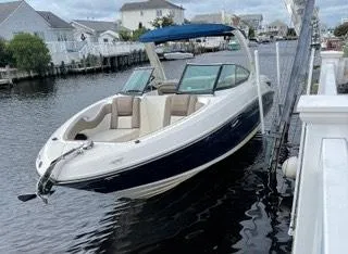 The Image of 2013 Sea Ray 300 SLX boat docked in a residential canal. - 0