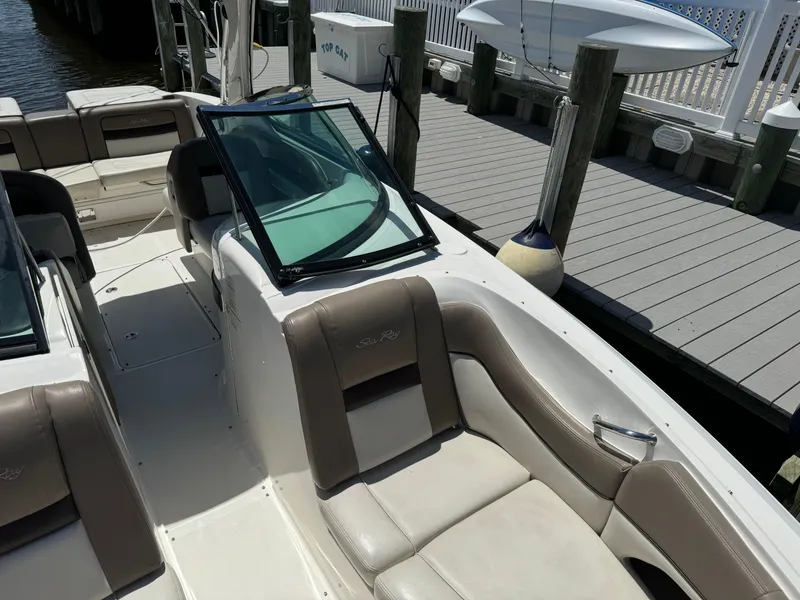 Slide: The Image of 2013 Sea Ray 300 SLX boat interior at dock with beige seating. - 10