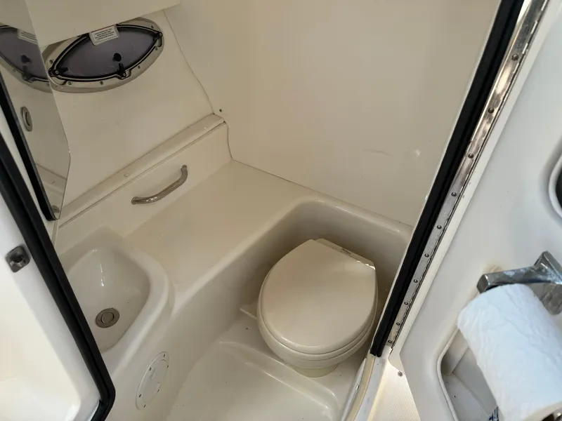 Slide: The Image of 2013 Sea Ray 300 SLX boat bathroom with toilet and sink. - 15