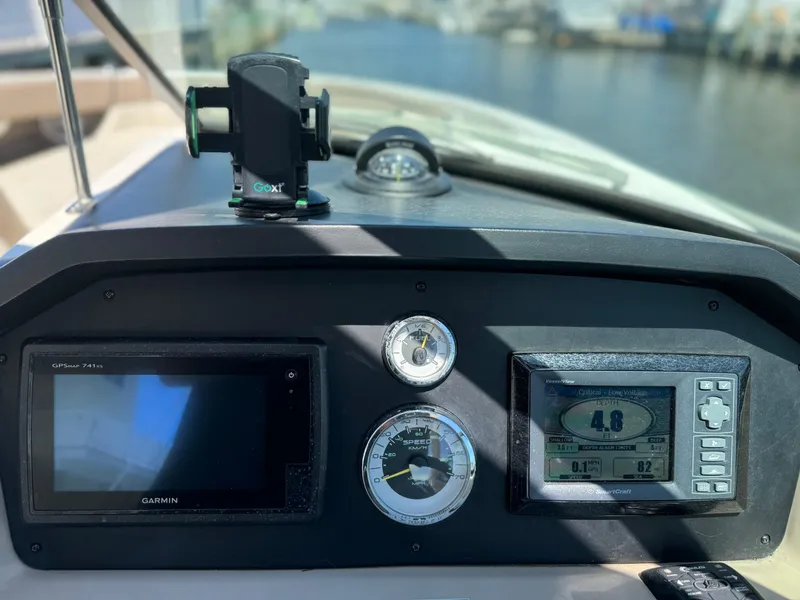 Slide: The Image of Dashboard of a 2013 Sea Ray 300 SLX boat with Garmin navigation. - 4