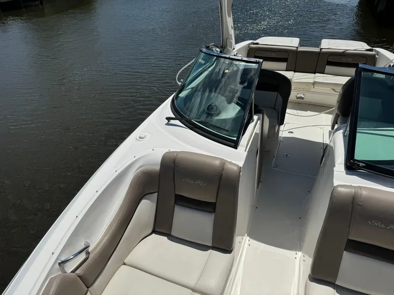 Slide: The Image of 2013 Sea Ray 300 SLX boat interior with beige seating and windshield. - 9