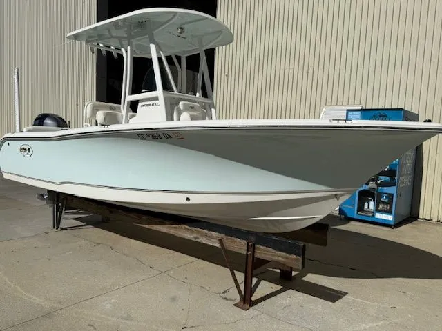 Slide: The Image of 2019 Sea Hunt Ultra 211 boat on a dock. - 2