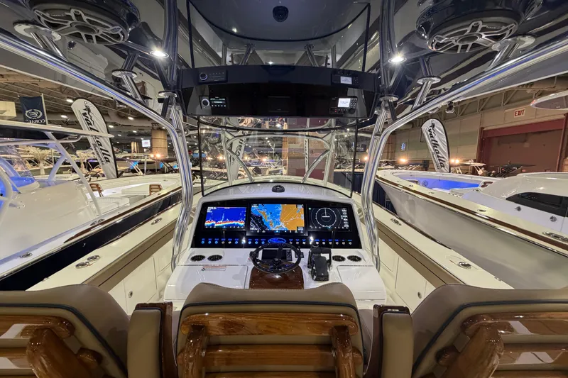 Slide: The Image of 2026 Valhalla Boatworks V-41 cockpit with advanced navigation displays at a boat show. - 6