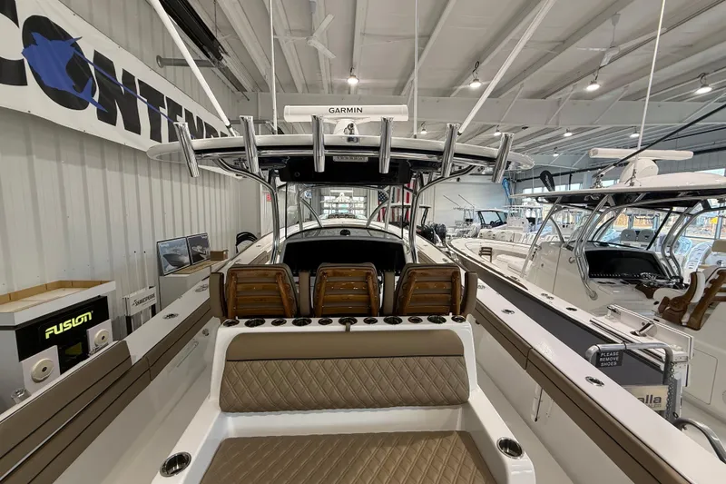 Slide: The Image of 2026 Valhalla Boatworks V-41 interior, showcasing seating and helm in a showroom. - 8