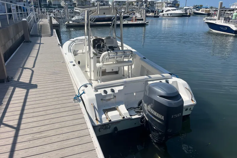 Slide: The Image of 2014 Sea Hunt Ultra 211 boat docked with Yamaha 150 engine in marina. - 11