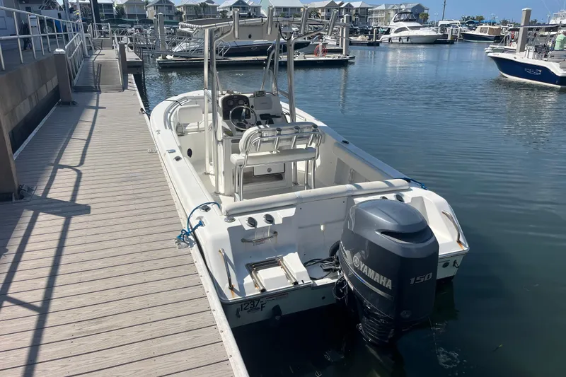 Slide: The Image of 2014 Sea Hunt Ultra 211 boat docked with Yamaha 150 engine in marina. - 12