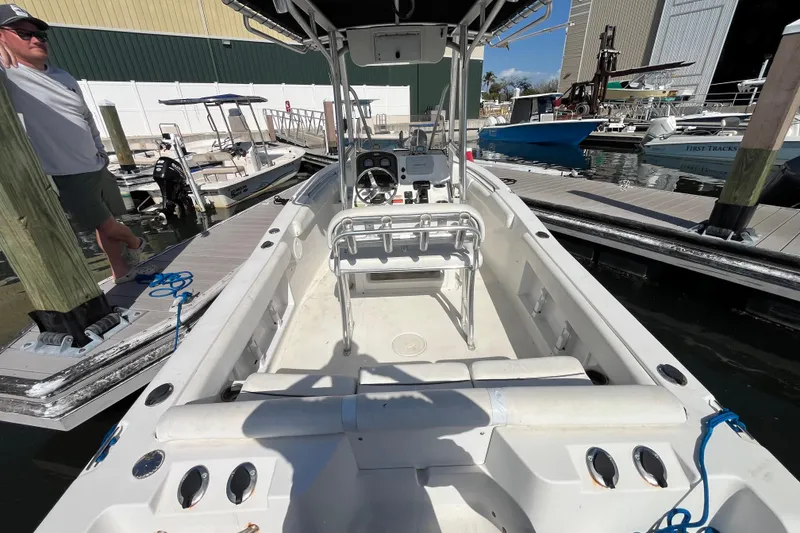 Slide: The Image of 2014 Sea Hunt Ultra 211 boat docked at marina, interior view with console and seating. - 14