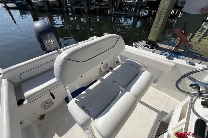 Slide: The Image of 2014 Sea Hunt Ultra 211 boat interior with Yamaha 150 engine at dock. - 15