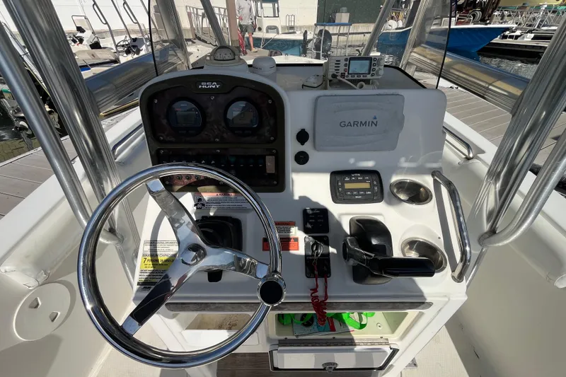 Slide: The Image of 2014 Sea Hunt Ultra 211 boat dashboard with Garmin navigation system and steering wheel. - 18