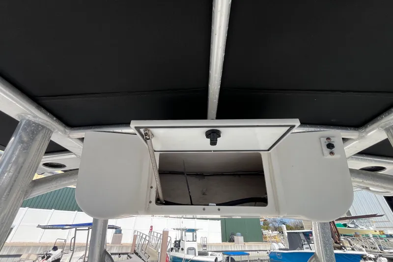 Slide: The Image of 2014 Sea Hunt Ultra 211 boat with open storage compartment under T-top. - 19