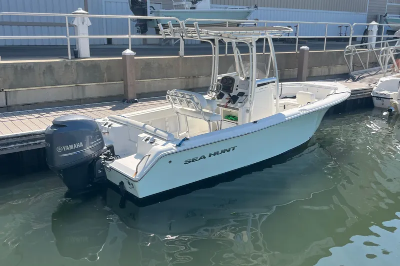 Slide: The Image of 2014 Sea Hunt Ultra 211 boat docked with Yamaha outboard motor. - 8