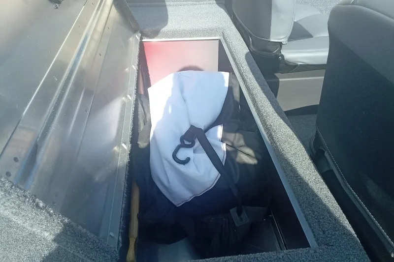 Slide: The Image of Storage compartment in 2023 Tracker Bass Tracker Classic XL boat, containing gear and equipment. - 14