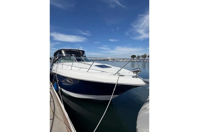 Slide: The Image of 2009 Chaparral Signature 290 boat docked under a clear blue sky. - 11