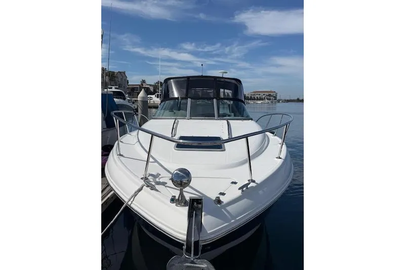 Slide: The Image of 2009 Chaparral Signature 290 boat docked at marina under blue sky. - 2