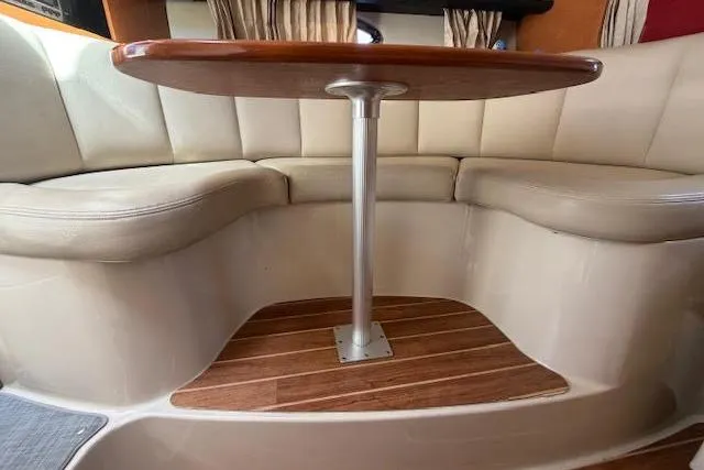 Slide: The Image of 2009 Chaparral Signature 290 interior with cushioned seating and wooden table. - 3