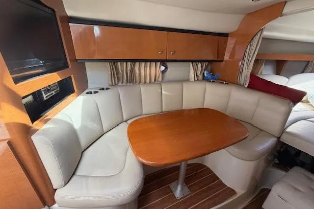 Slide: The Image of Interior of 2009 Chaparral Signature 290 with cozy seating and wooden table. - 5