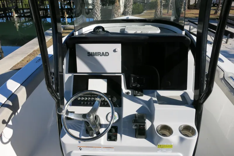 Slide: The Image of 2021 Sea Pro 239 Deep V CC boat console with Simrad electronics and steering wheel. - 14