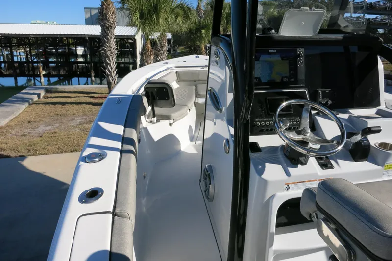 Slide: The Image of 2021 Sea Pro 239 Deep V CC boat interior with steering console and seating. - 17