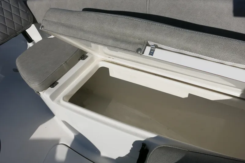 Slide: The Image of Open storage compartment on 2021 Sea Pro 239 Deep V CC boat with cushioned seating. - 22