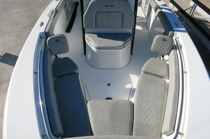 Slide: The Image of 2021 Sea Pro 239 Deep V CC boat interior with gray seating and spacious layout. - 25