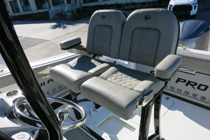 Slide: The Image of 2021 Sea Pro 239 Deep V CC boat with dual cushioned seats and steering wheel. - 31