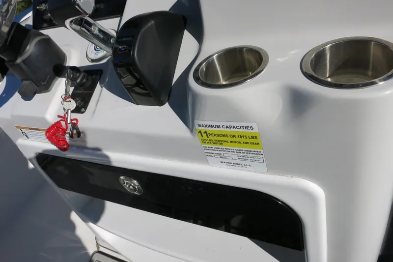 Slide: The Image of 2021 Sea Pro 239 Deep V CC boat console with controls and capacity label. - 35
