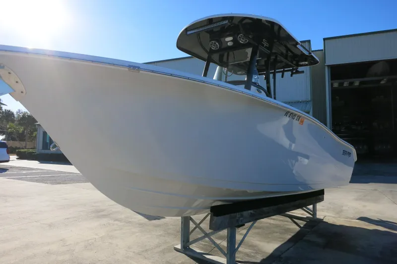 Slide: The Image of 2021 Sea Pro 239 Deep V CC boat on display in a sunny outdoor setting. - 4