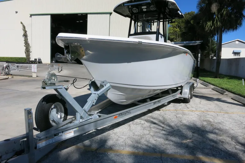 Slide: The Image of 2021 Sea Pro 239 Deep V CC boat on trailer in sunny outdoor setting. - 48