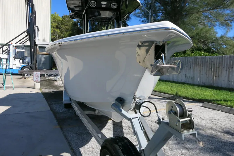 Slide: The Image of 2021 Sea Pro 239 Deep V CC boat on trailer, parked outdoors near a building. - 49