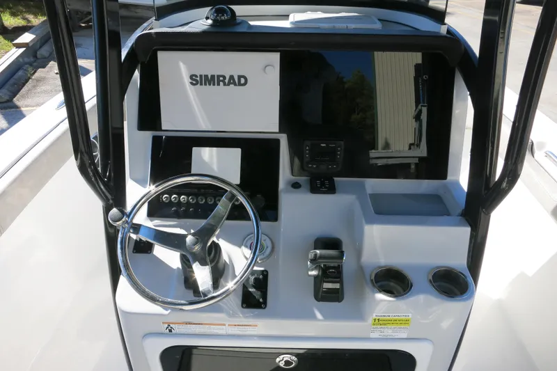Slide: The Image of 2021 Sea Pro 239 Deep V CC boat console with Simrad electronics and steering wheel. - 53