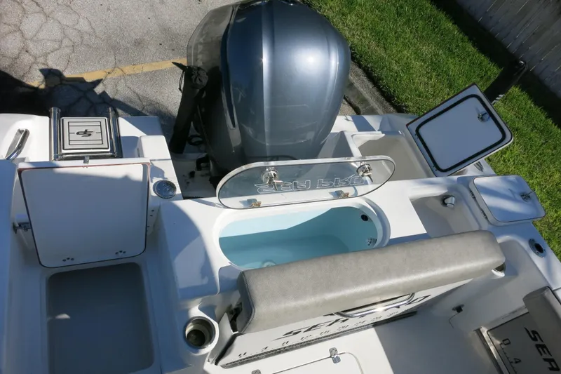 Slide: The Image of 2021 Sea Pro 239 Deep V CC boat with open compartments and engine view. - 55