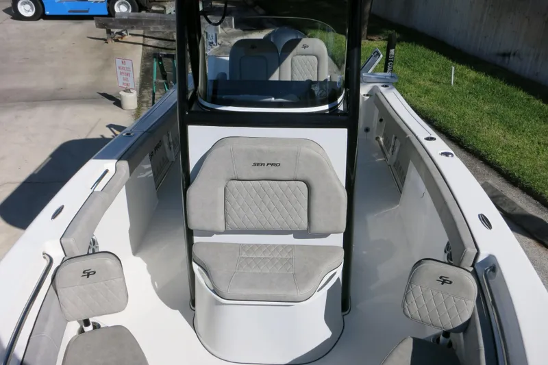 Slide: The Image of 2021 Sea Pro 239 Deep V CC boat interior with gray seating and console. - 59