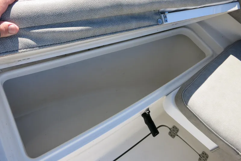 Slide: The Image of Storage compartment in 2021 Sea Pro 239 Deep V CC boat, open with cushioned lid. - 61