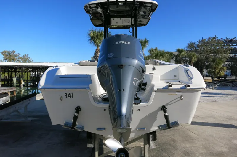 Slide: The Image of 2021 Sea Pro 239 Deep V CC boat with powerful outboard motor, docked under clear blue sky. - 7