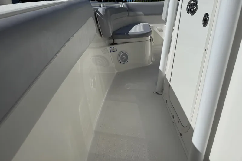 Slide: The Image of 2018 NauticStar 28 XS boat interior with seating and storage compartments. - 16